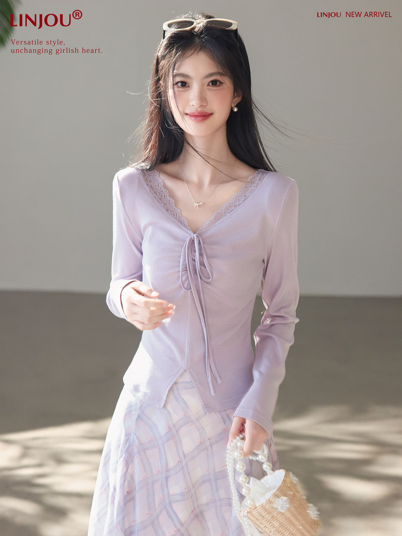 Model wearing a light lavender lace-trim long-sleeve top with a pastel plaid skirt