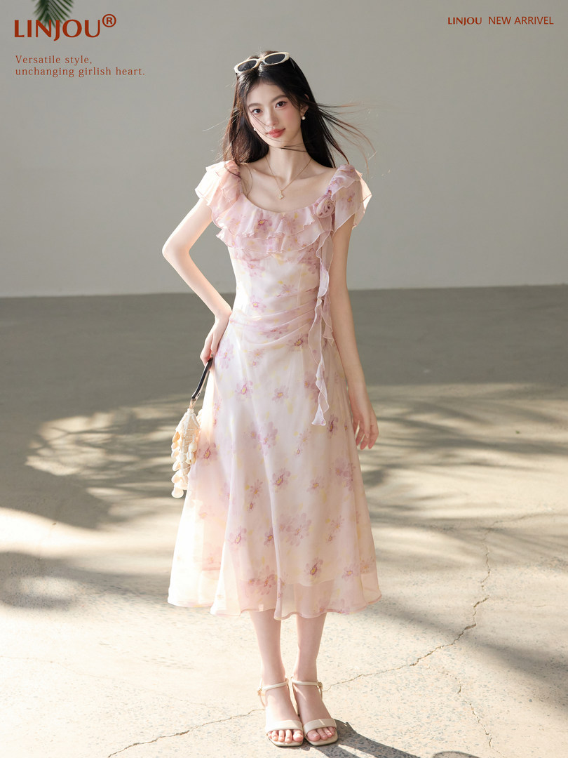 Model wearing a light pink floral ruffled midi dress