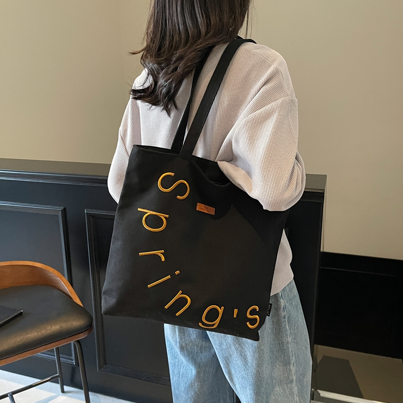 红鹮鸟刺绣字母帆布包包女2025大容量单肩手提袋小众百搭通勤