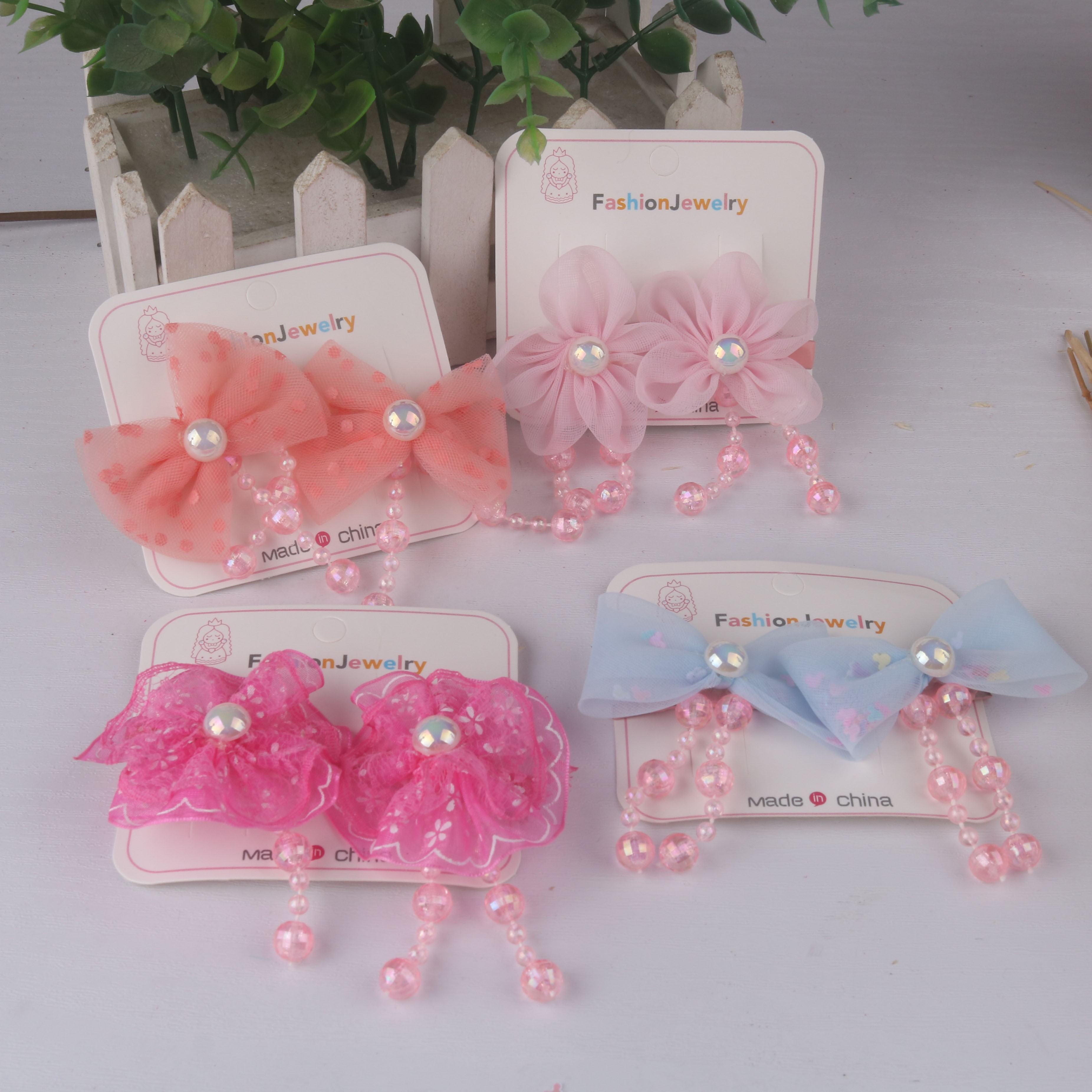 儿童布艺花朵蝴蝶结珠子流苏货源