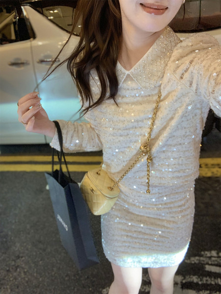 Woman wearing a sparkly cream sequin mini dress