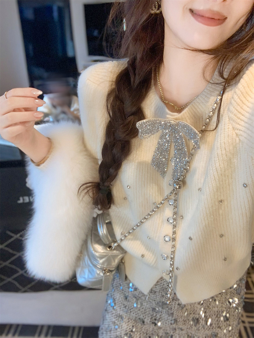 Woman wearing a cream embellished sweater with a glittery silver skirt