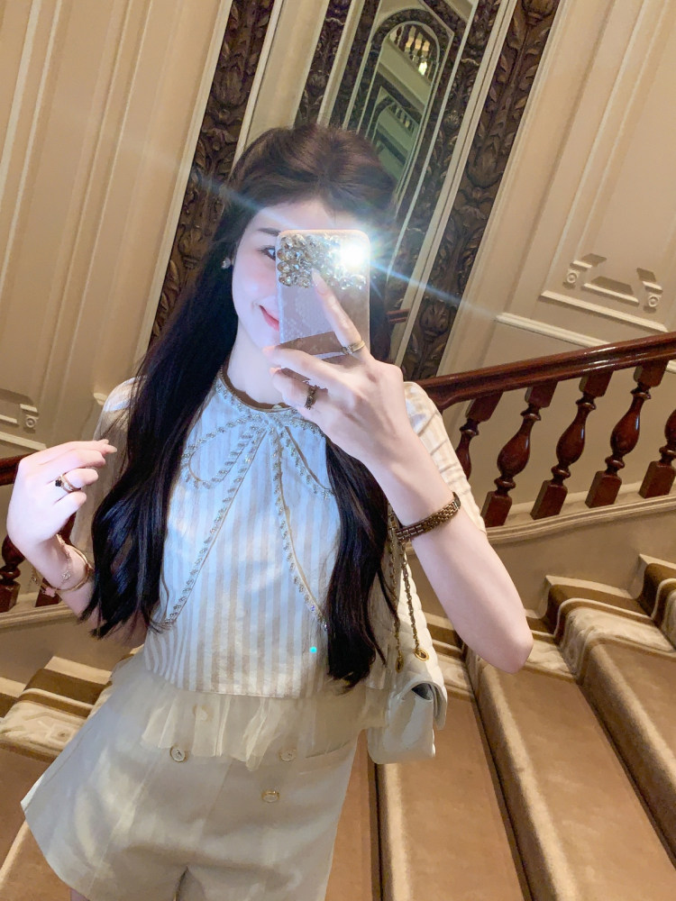 Light-colored feminine outfit worn in a mirror selfie