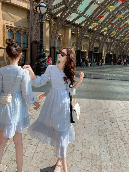 Light blue sheer long-sleeve dress worn by a woman outdoors