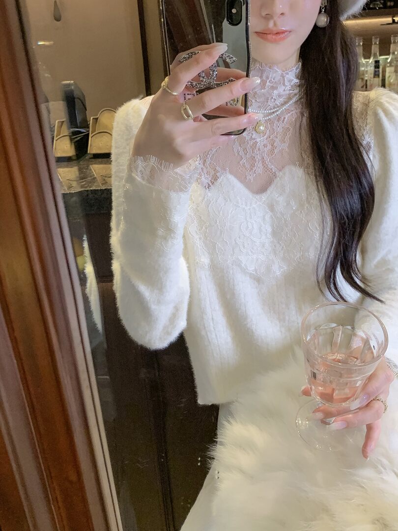 Woman wearing a white lace dress or top in a mirror selfie