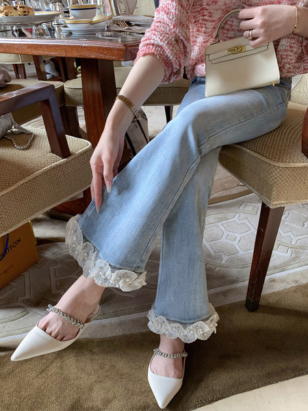 Light blue flared jeans with ruffled hems worn with white pointed slingback shoes