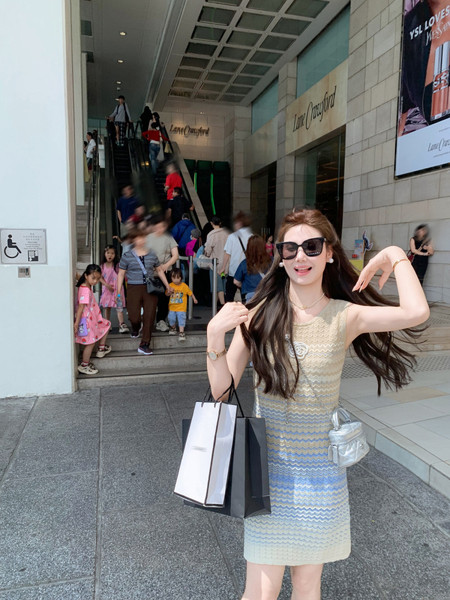 Woman wearing a sleeveless pastel zigzag knit dress outdoors