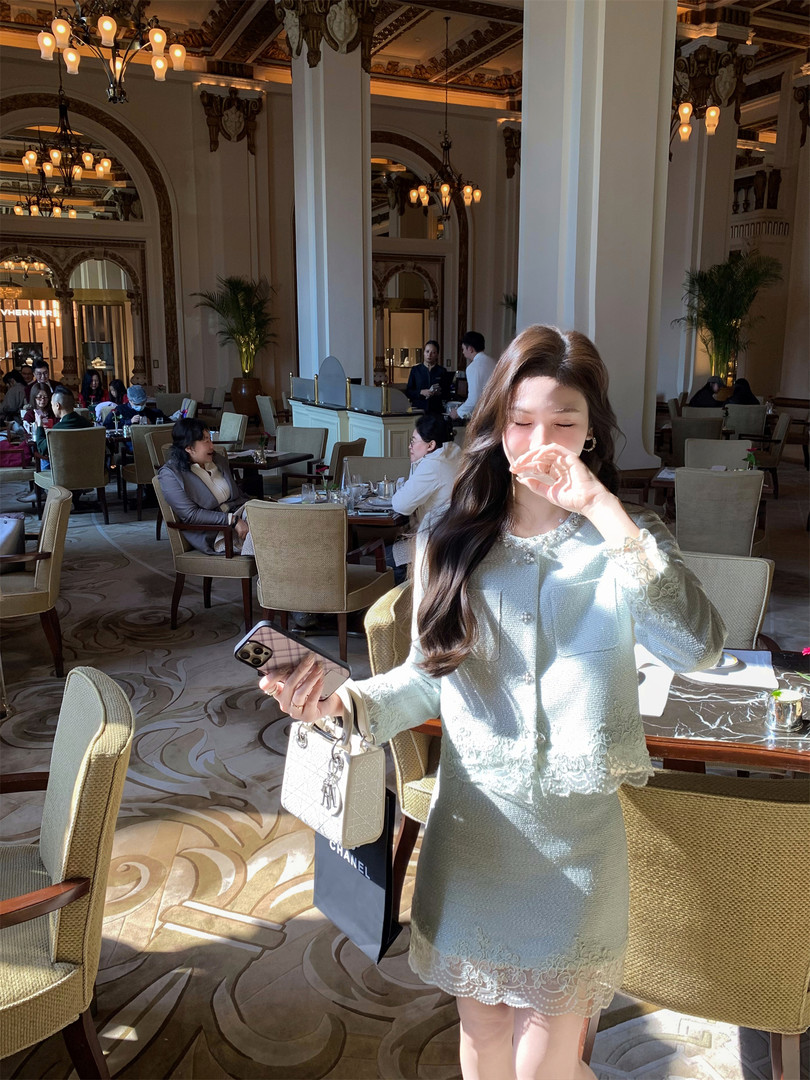 Woman wearing a light mint lace dress in a luxury restaurant