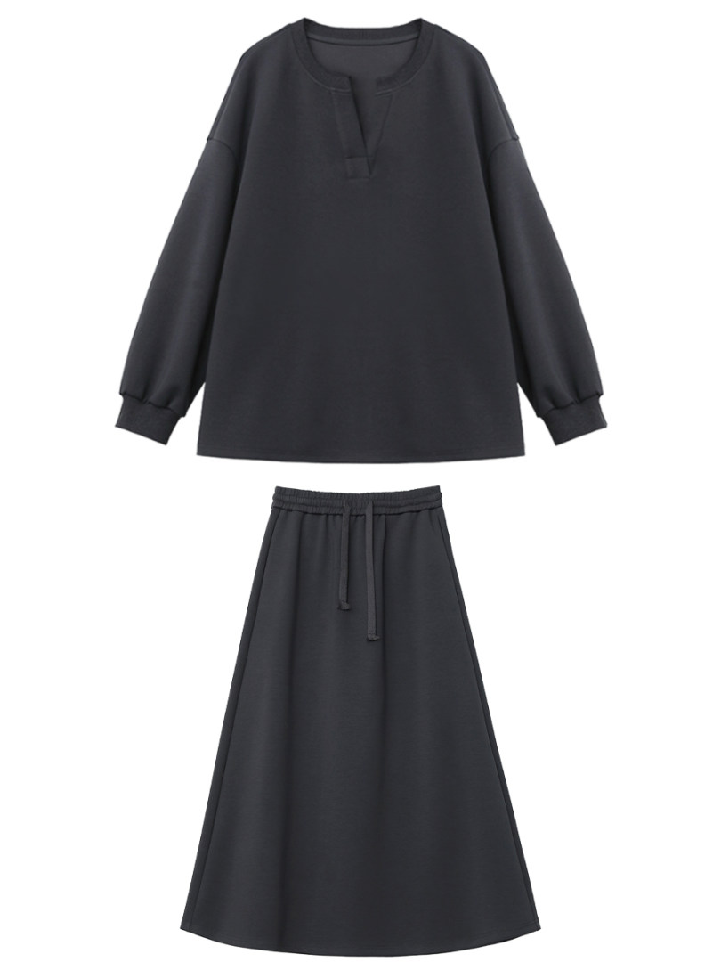 Black long-sleeve top and matching skirt set on a white background