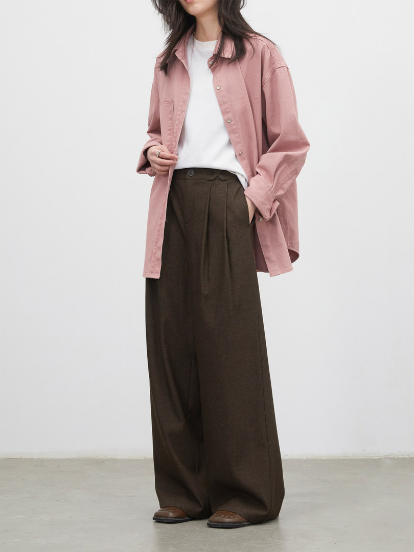 Model wearing a pink button-up shirt with brown wide-leg trousers