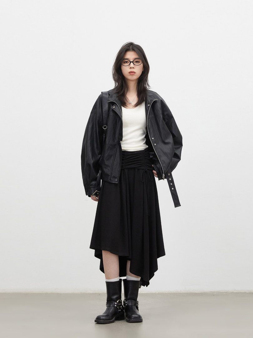 Model wearing a black leather jacket, black skirt, and black boots