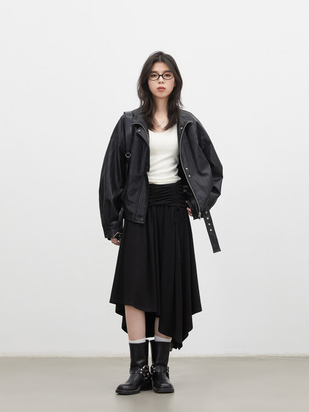 Model wearing a black leather jacket, black skirt, and black boots