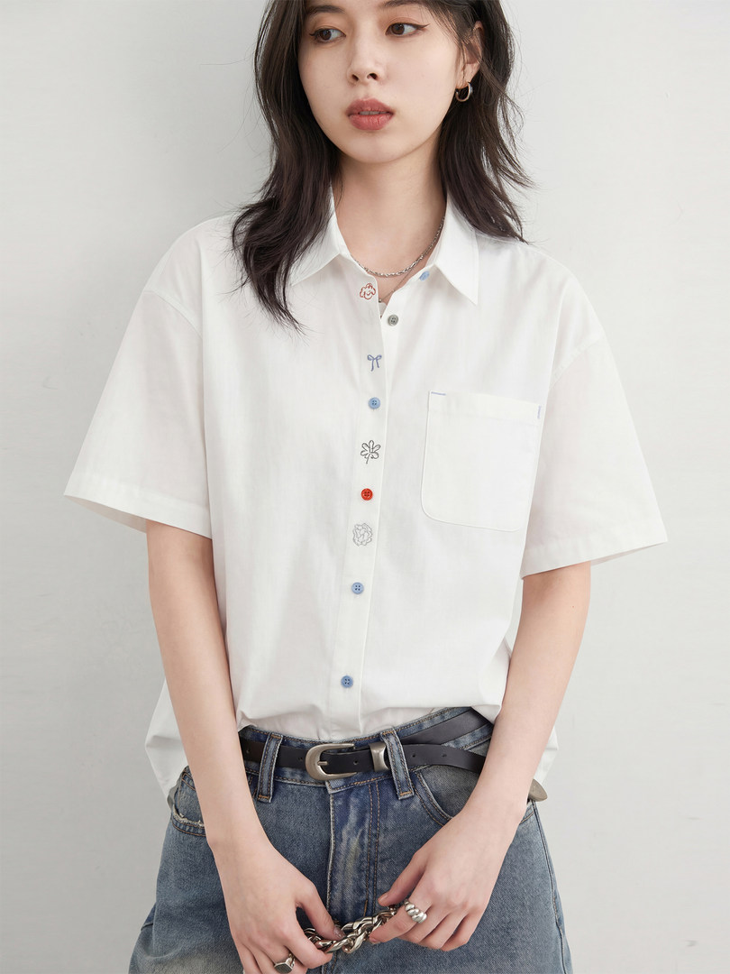 White short-sleeve button-up shirt worn by a model