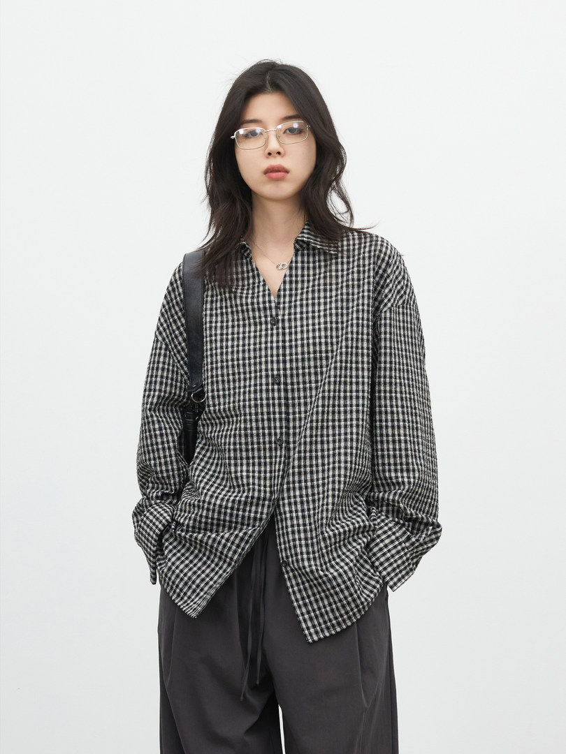 Model wearing a black-and-white checkered long-sleeve shirt