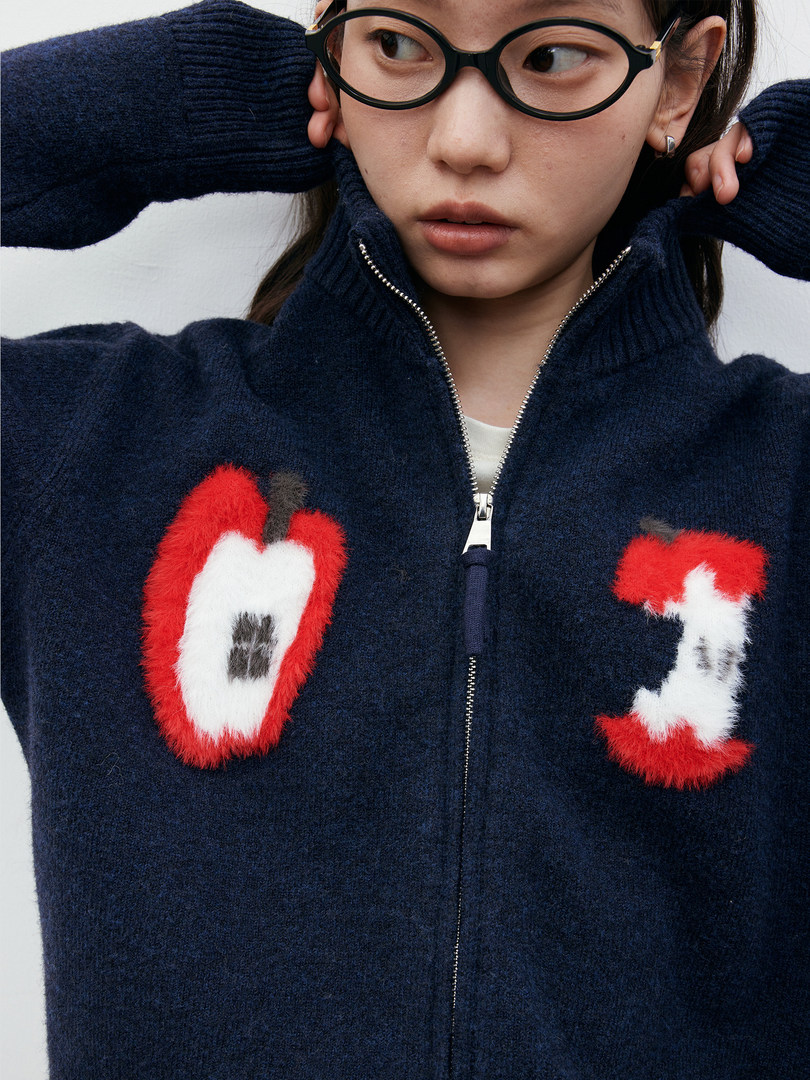 Navy fuzzy zip-up sweater worn by a model