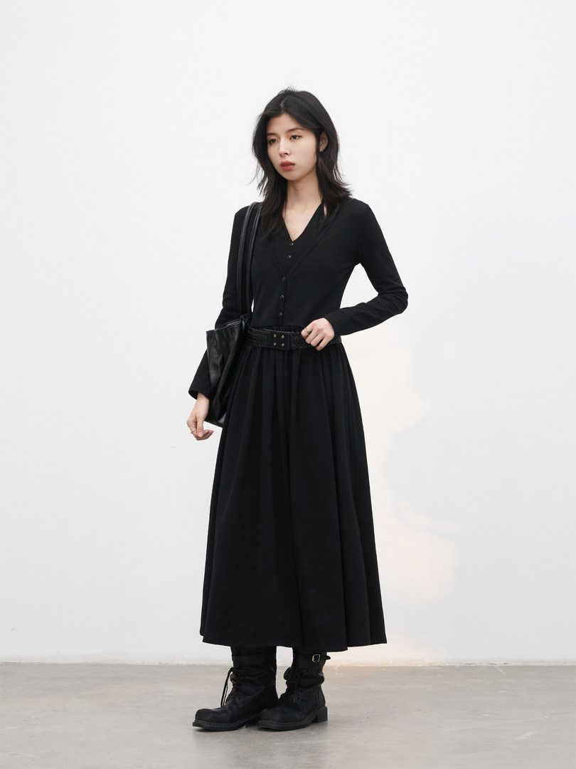 Black long-sleeve midi dress worn with boots and a shoulder bag on a model