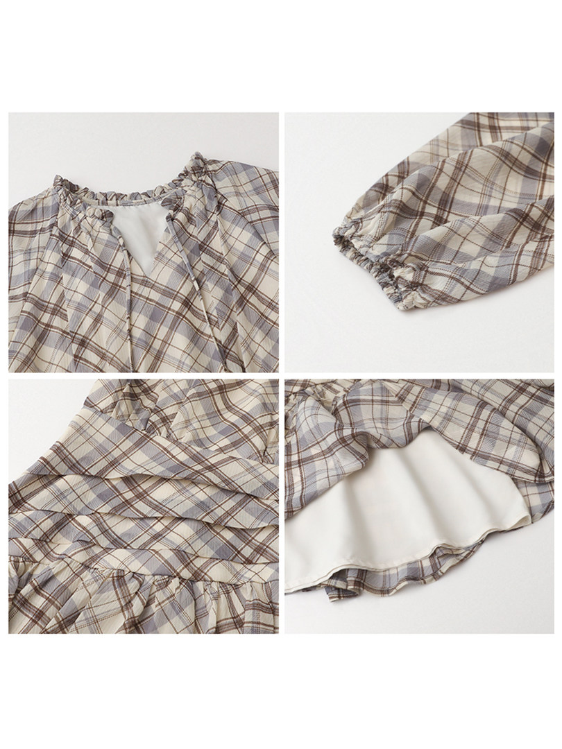 Plaid ruffled long-sleeve dress laid flat on a white background