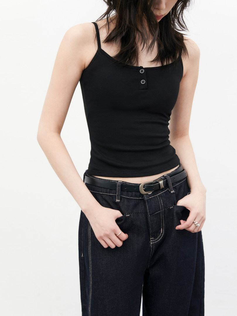Black spaghetti-strap tank top worn with dark jeans on a model