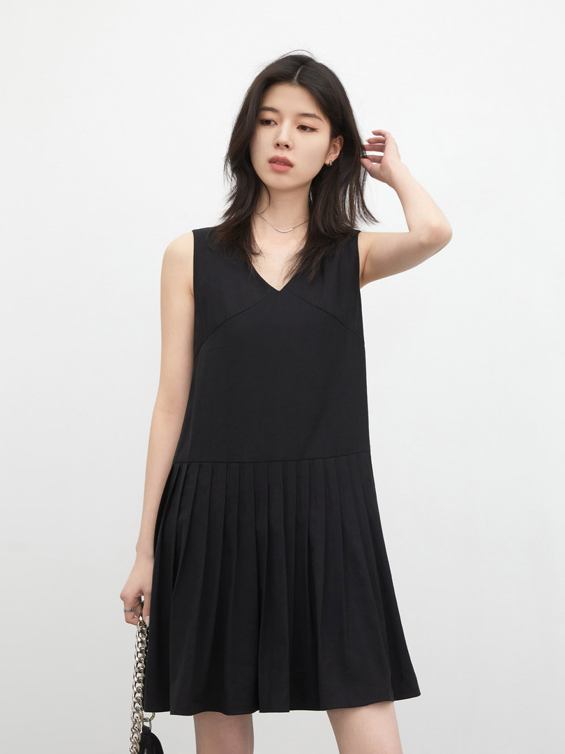 Black sleeveless pleated dress worn by a model