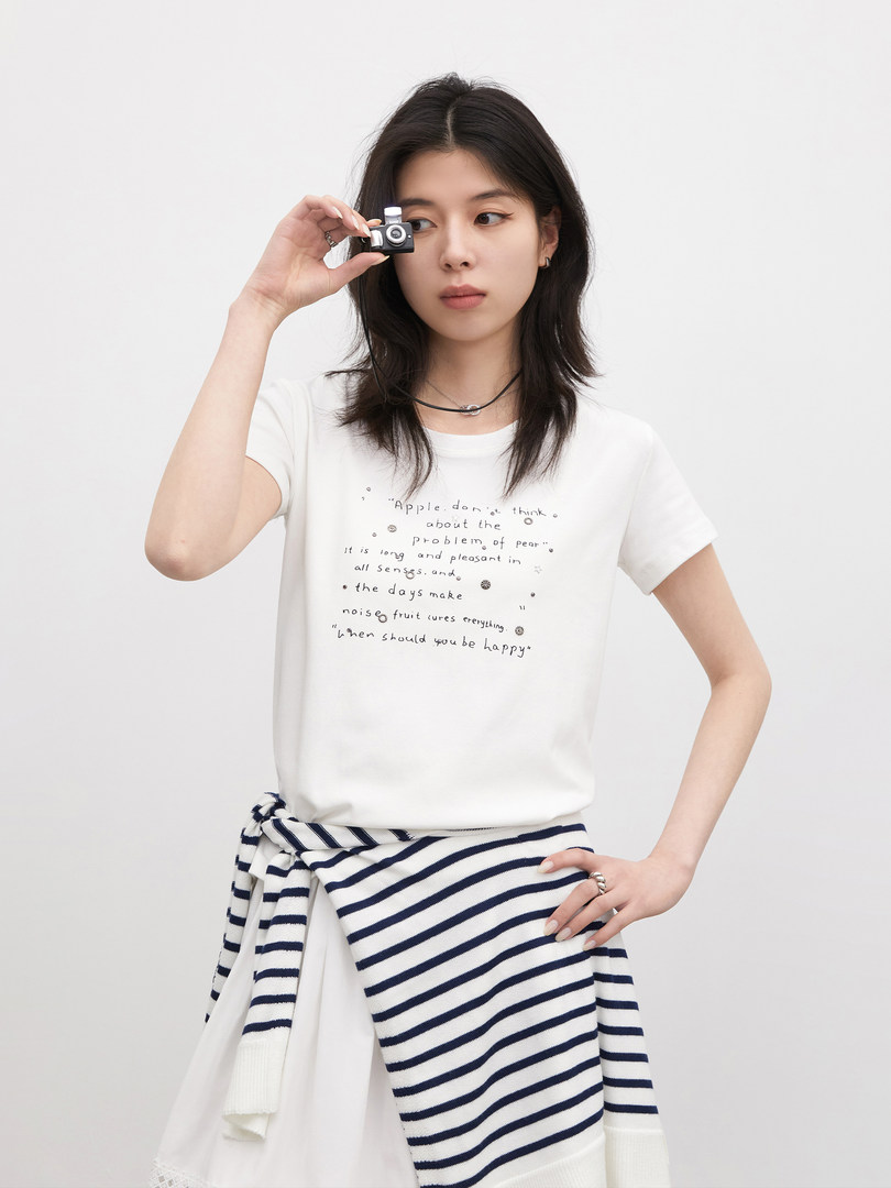 Model wearing a white printed T-shirt with a striped wrap tied at the waist
