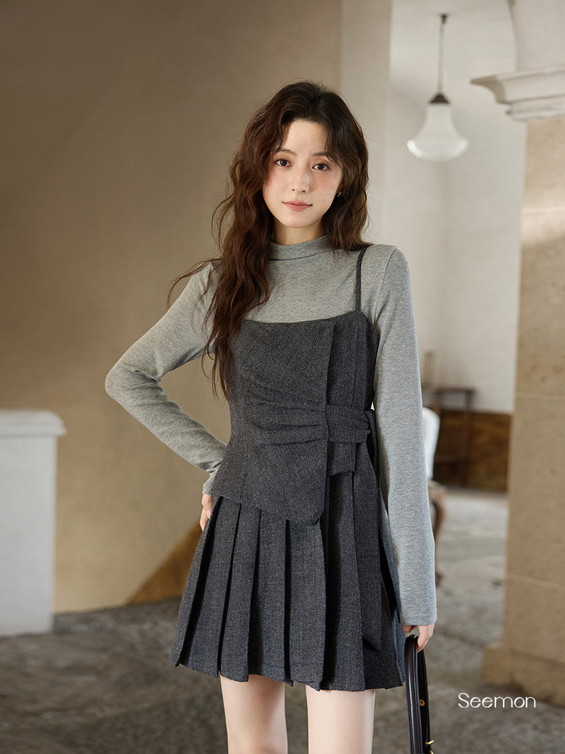 Model wearing a gray long-sleeve pleated mini dress
