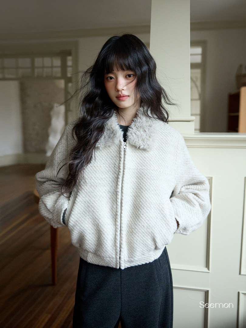 Light beige fluffy zip-up jacket worn by a model