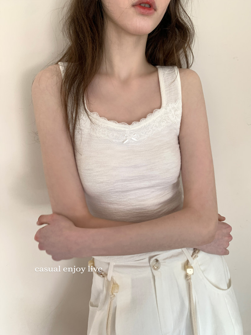 White lace-trim sleeveless top worn by a model