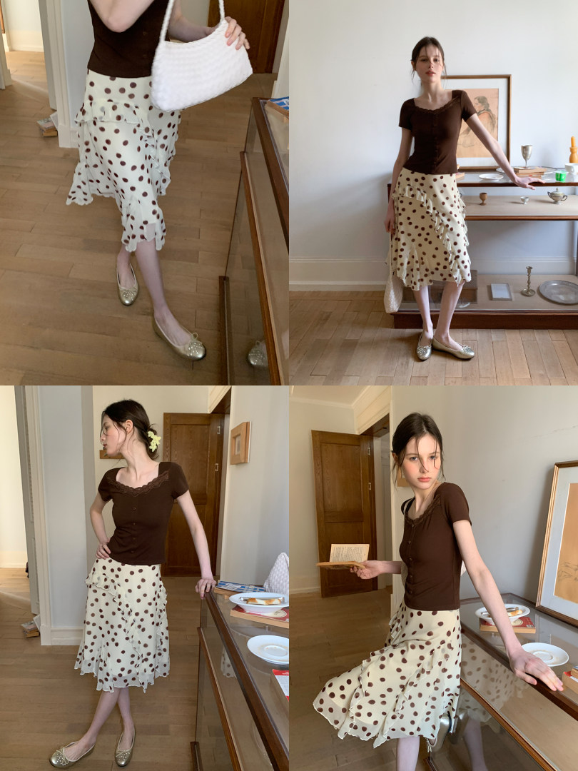 Model wearing a brown short-sleeve top with a cream polka dot ruffled skirt
