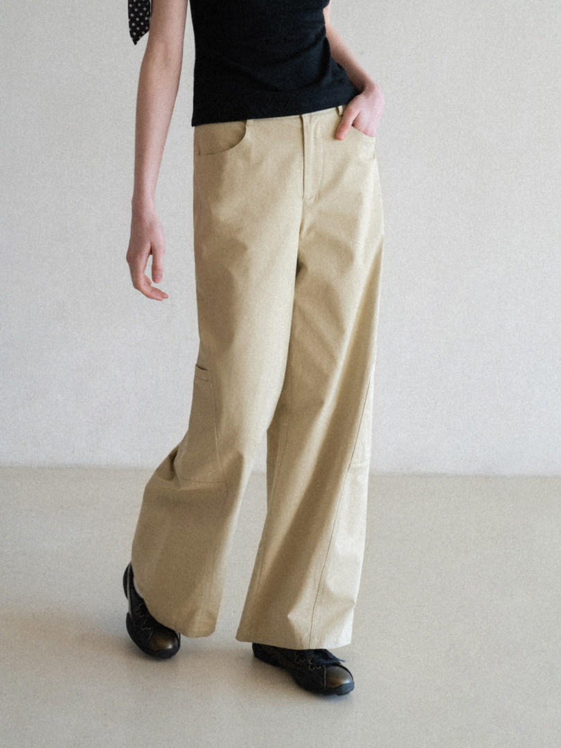 Beige wide-leg pants worn with a black top and black shoes