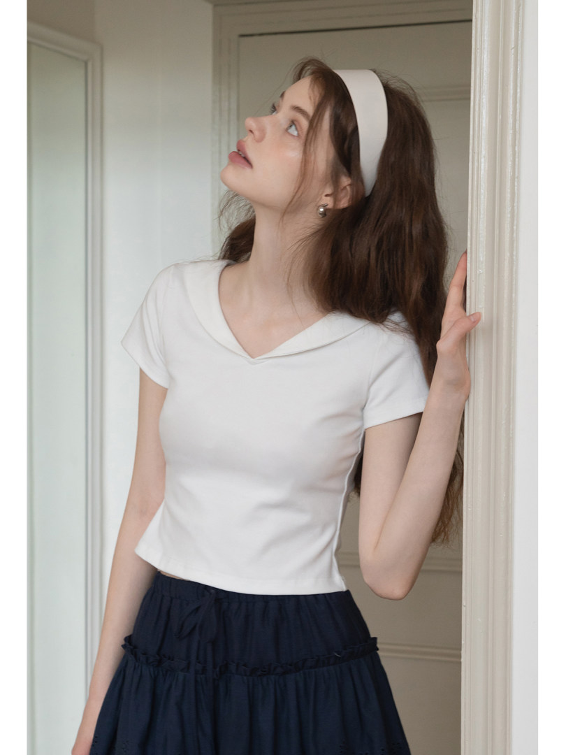 White short-sleeve fitted top worn by a model