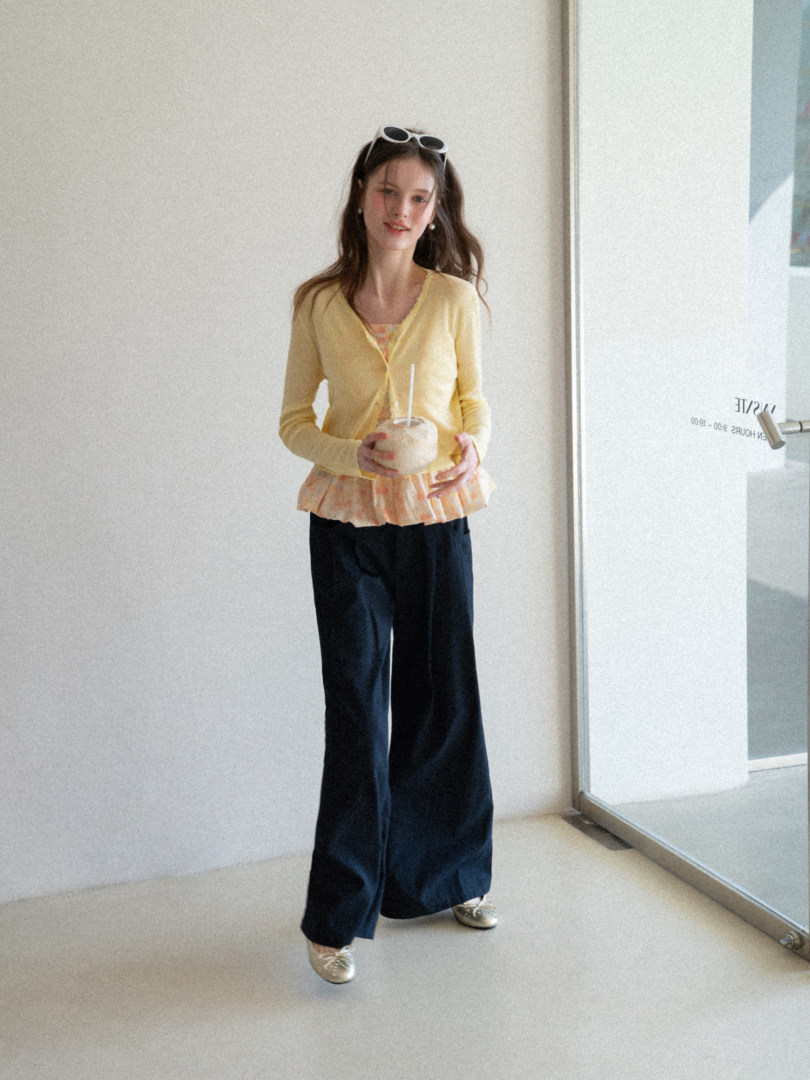 Model wearing a yellow cardigan with navy wide-leg pants
