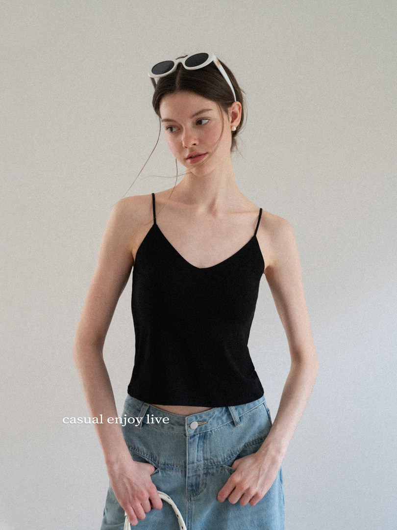 Black camisole top worn with light blue jeans