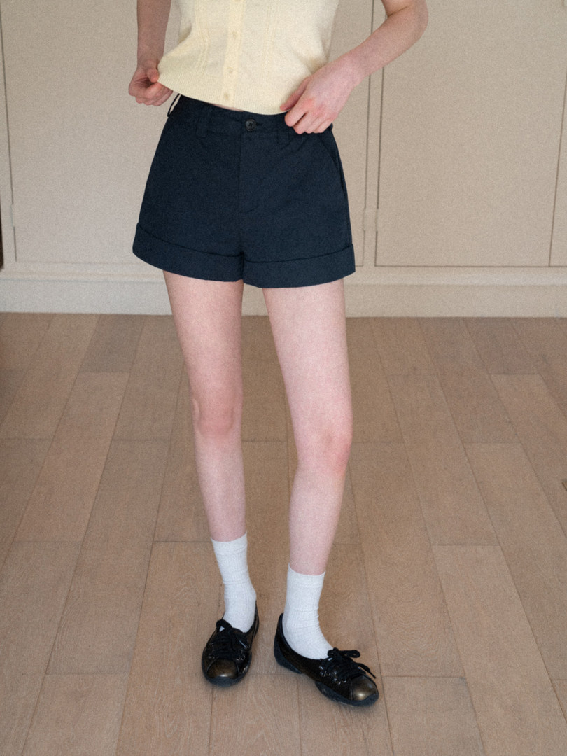 Black high-waisted shorts worn by a model