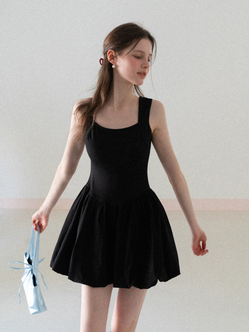 Black sleeveless dress worn by a model