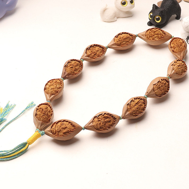 橄榄核雕刻十二生肖本命佛八大守护神长串手持男包衣原皮素核单面