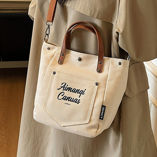 今年流行休闲手拎帆布包女式2026新款秋冬时尚简约字母单肩斜挎包