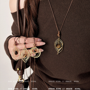 复古轻奢美拉德金属线缠绕虎眼石吊坠项链女长款毛衣链配饰高级感