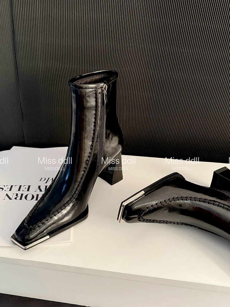 Black pointed-toe ankle boots with block heels and side zippers