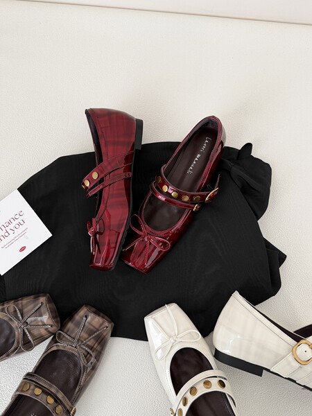 Assorted patent leather Mary Jane flats displayed on a neutral background