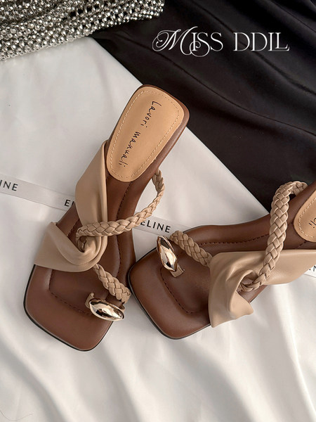 Pair of beige and brown braided heeled sandals
