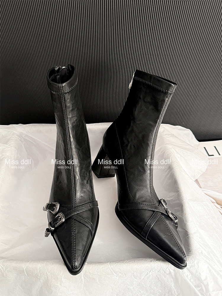 Black heeled ankle boots with pointed toes and buckle detail
