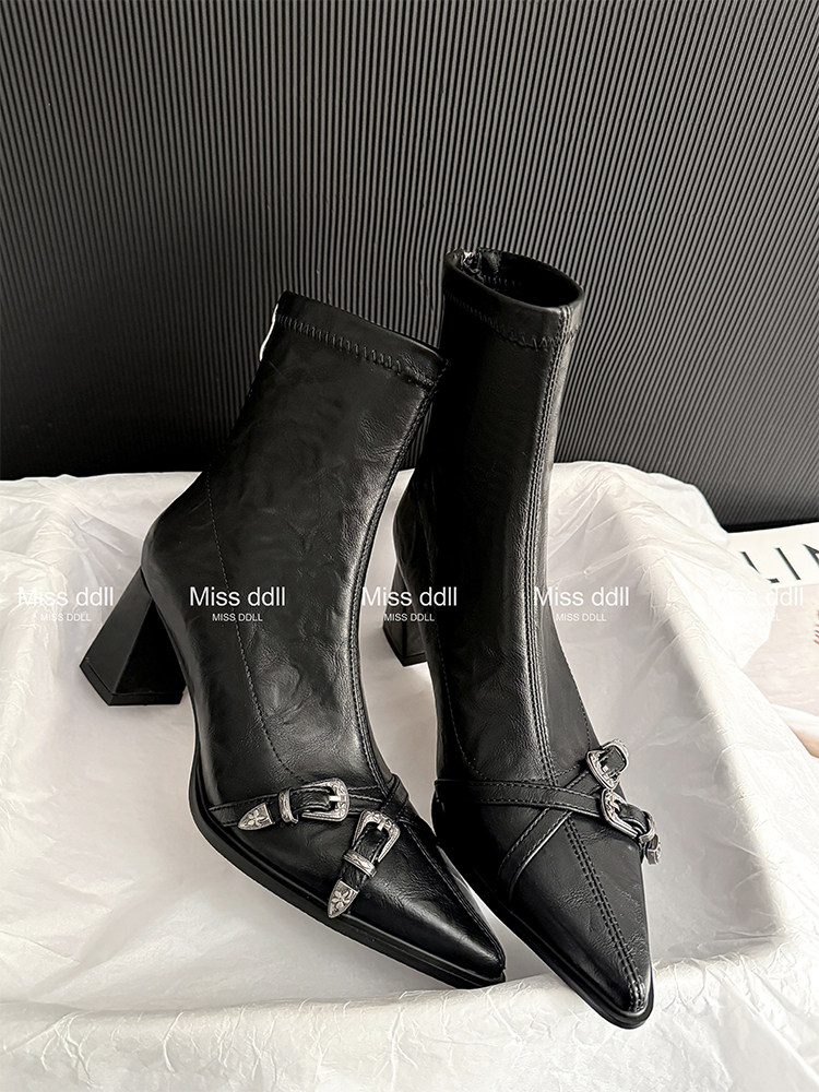 Black pointed-toe heeled ankle boots with buckle details