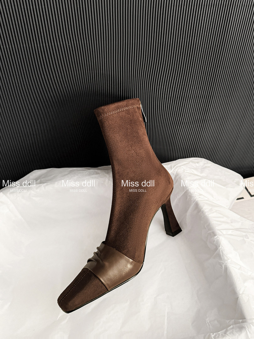 Brown heeled ankle boot displayed on a white surface