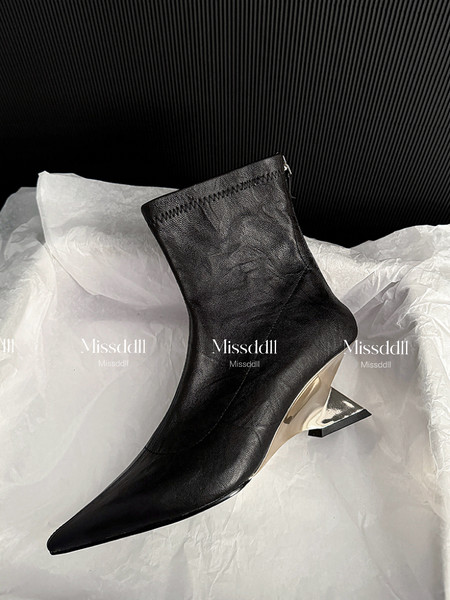 Black pointed-toe ankle boot with a metallic heel