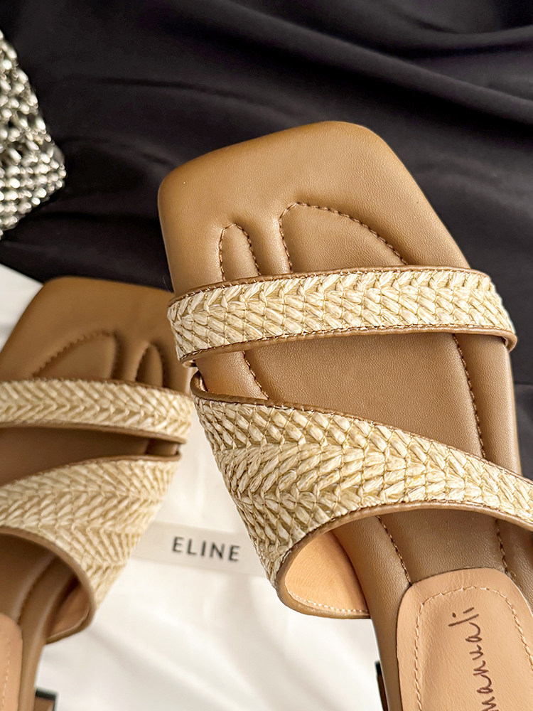 Pair of tan woven slide sandals with braided straps