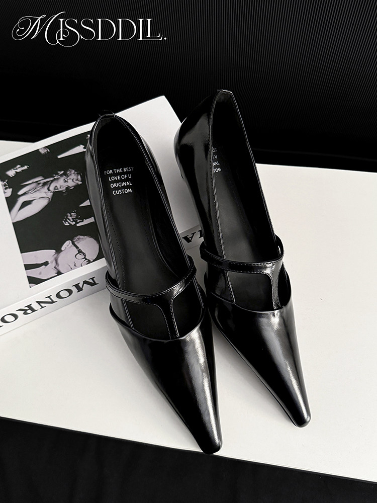 Black pointed-toe high-heel shoes on a white surface