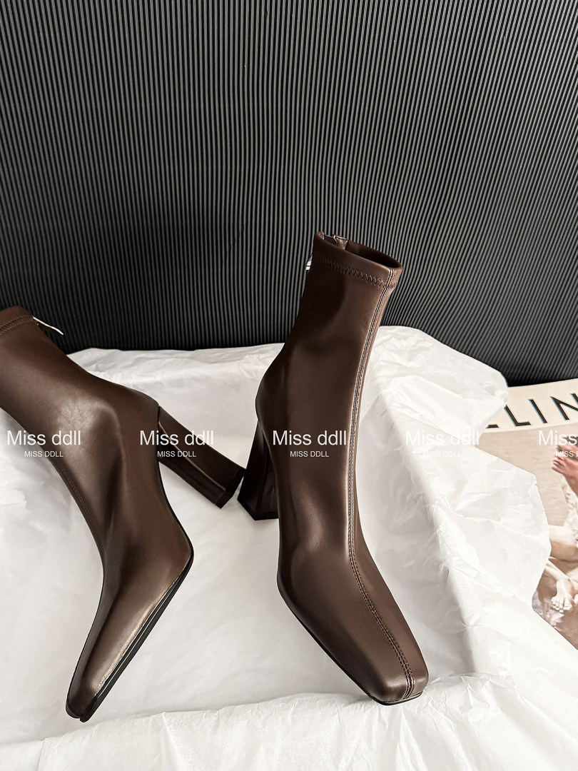 Brown pointed-toe heeled ankle boots displayed on white paper