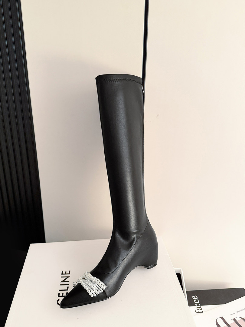 Black over-the-knee pointed-toe boot with a decorative pearl detail