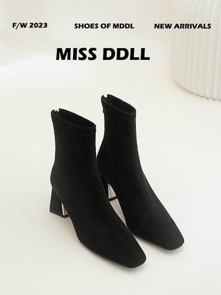 Black ankle boots with block heels on a white background