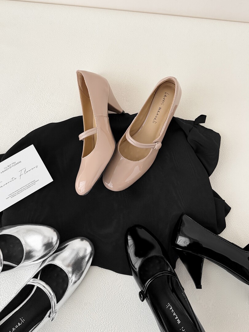 Assorted low-heel Mary Jane pumps displayed on a black cloth
